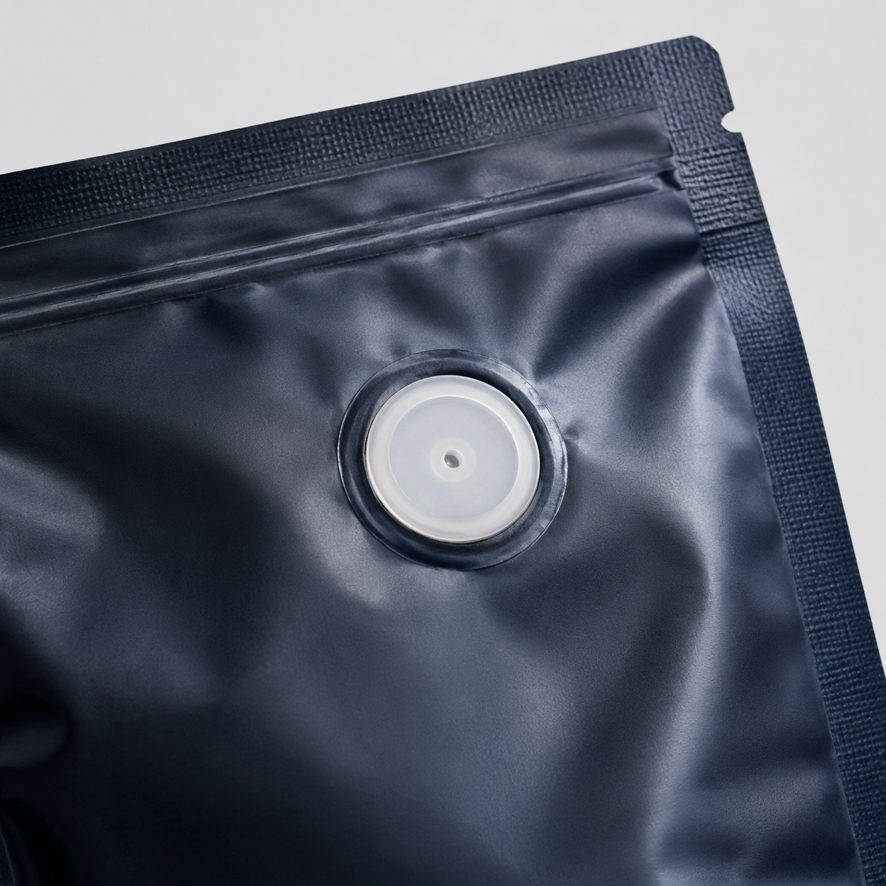 Close-up of a coffee degassing valve installed in intact pouch film