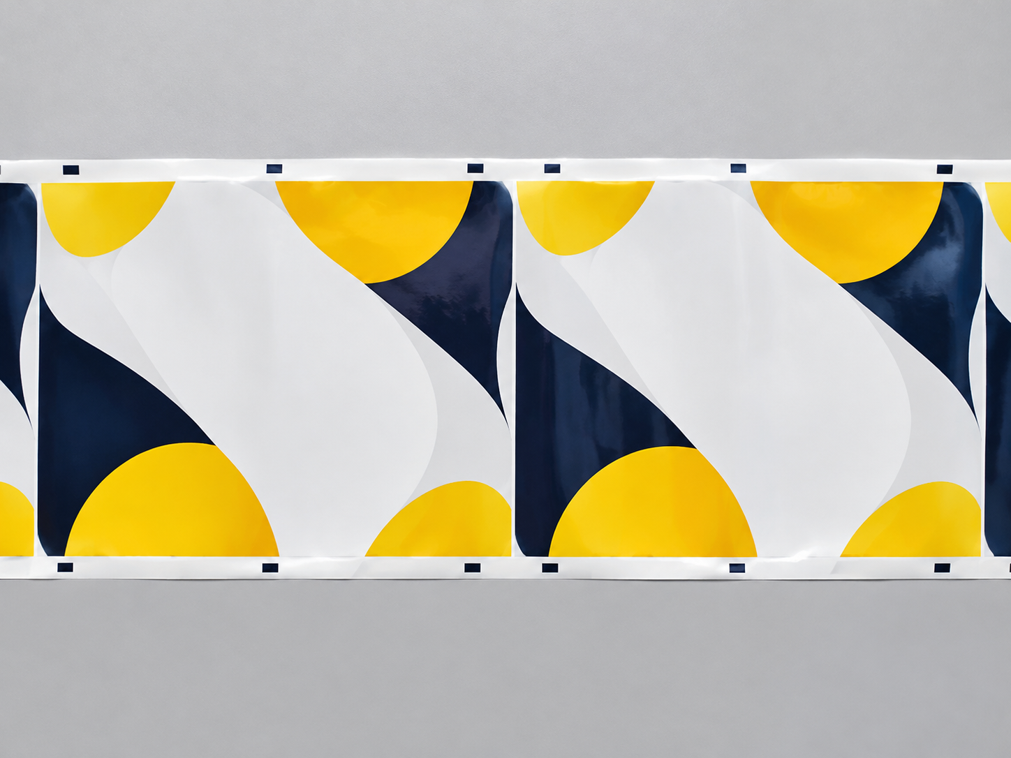 Flat rollstock film showing repeated artwork panels and registration marks near the web edge